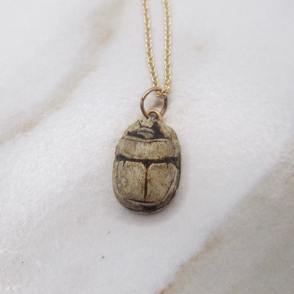 Necklace with a beetle pendant on a white background