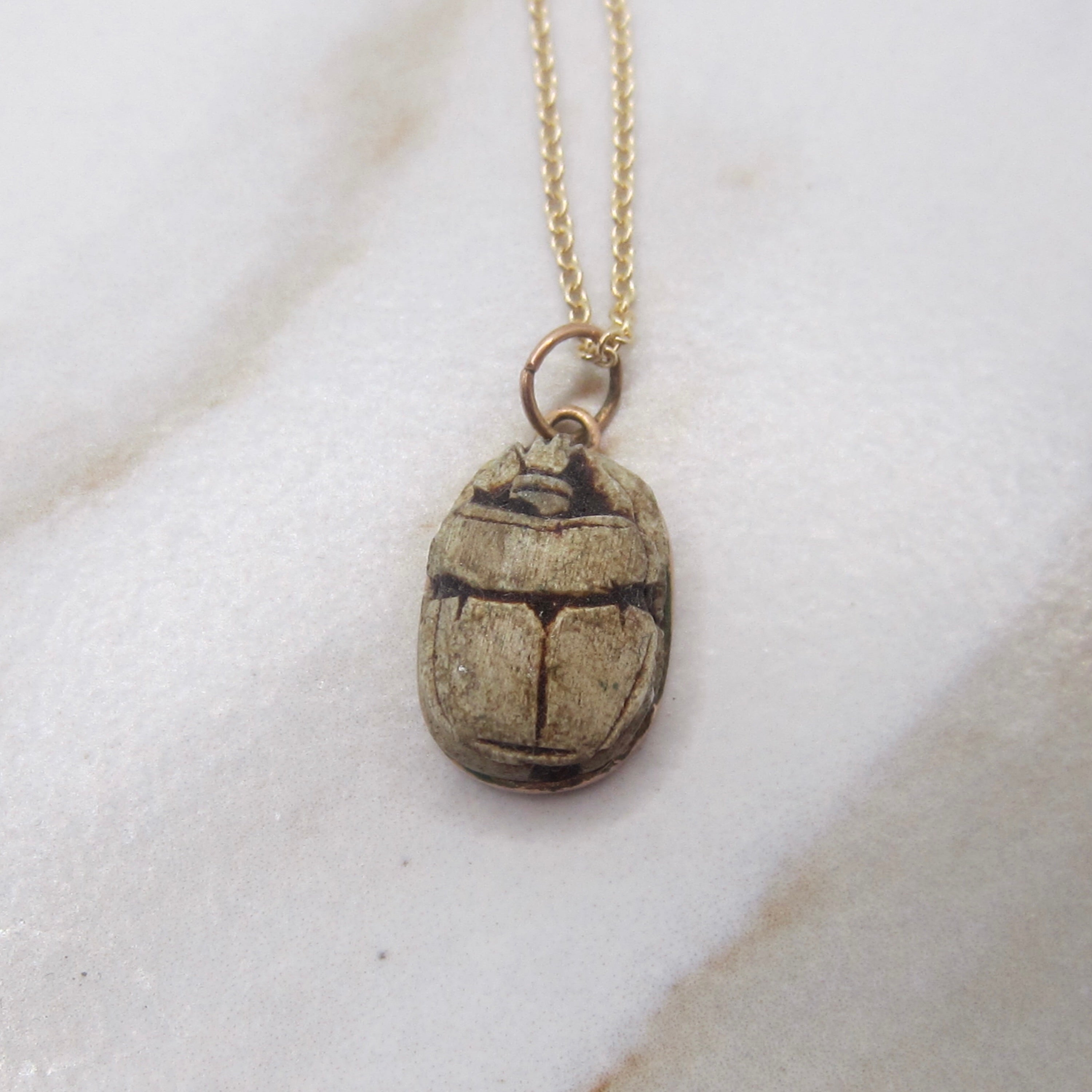 Necklace with a beetle pendant on a white background