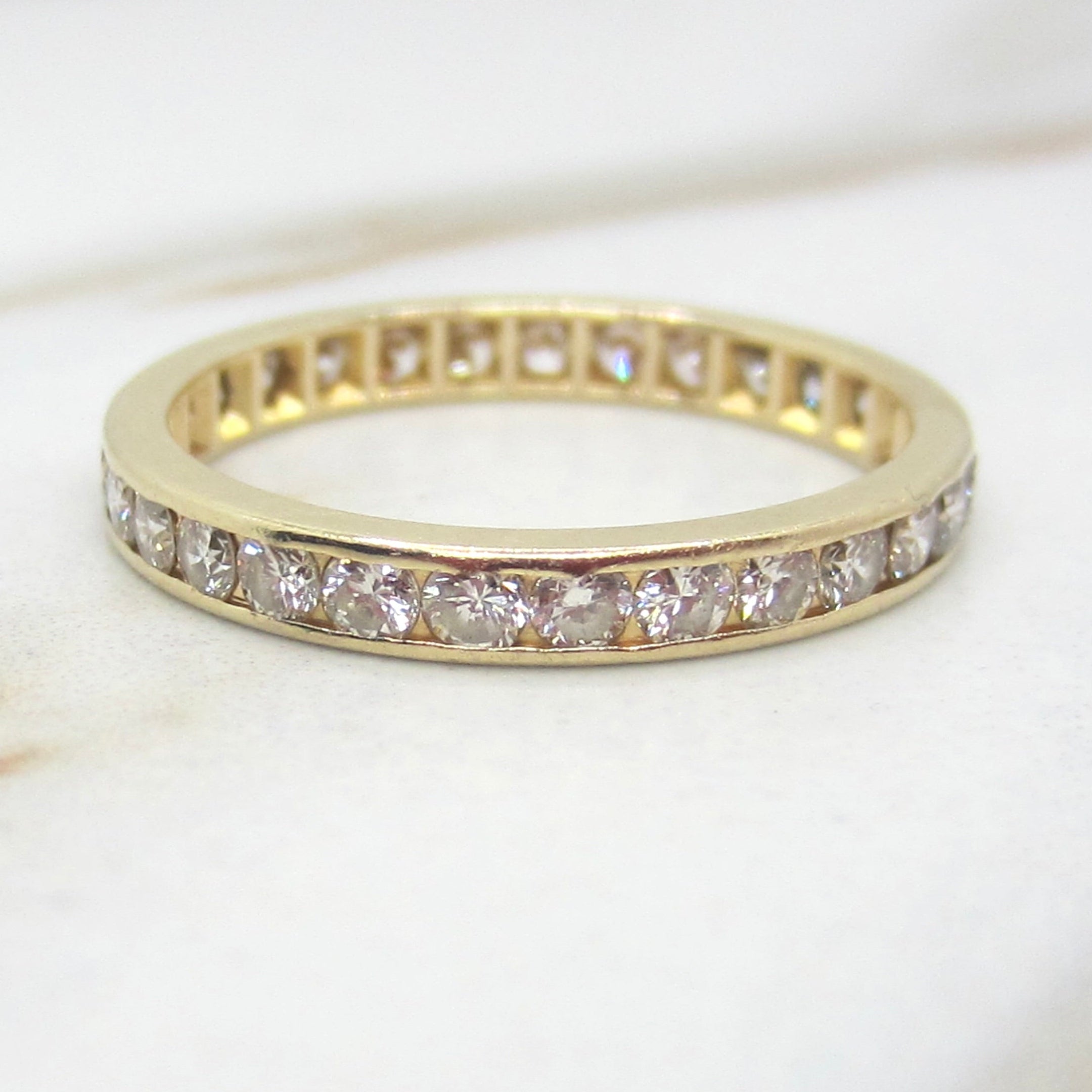 Gold ring with diamonds on a light background