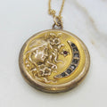 Gold necklace with a round pendant featuring a unicorn design on a white background